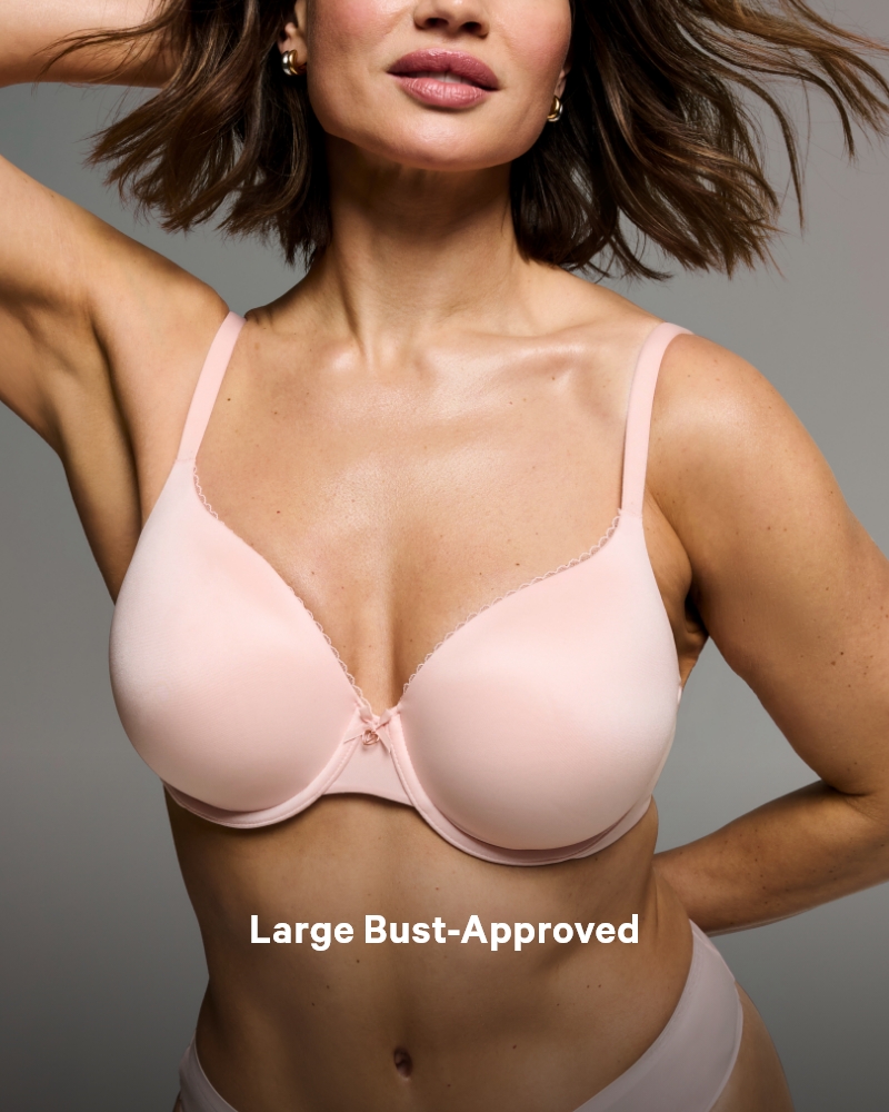 Woman posing in a Victoria's Secret full coverage baby pink bra.