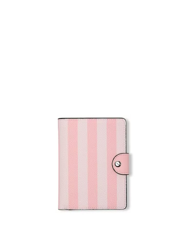 Victoria's Secret signature stripe passport cover on a light grey background.