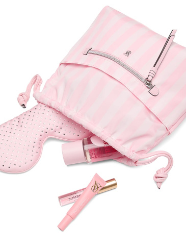 Victoria's Secret signature stripe cosmetic bag with cosmetic products falling out of it.
