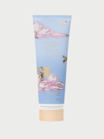Victoria's Secret sky blue tube of perfumed lotion on a light grey background