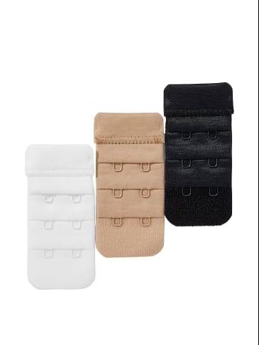 White, beige and black bra strap extenders on a light grey background.