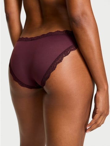 Back view of a woman wearing Victoria's Secret burgundy bikinis and briefs panties