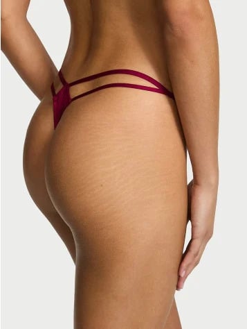 Back view of a woman wearing Victoria's Secret burgundy V-string thong panties