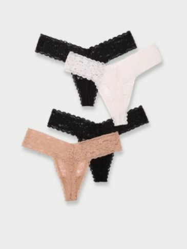 Black, white and beige Victoria's Secret pack of lace panties on a light grey background